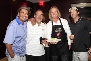George Lopez, left, Charley Hoffman, second from right, and guests at the Celebrity Servers fundraiser at Morton's Steakhouse on Sept. 26, 2011.