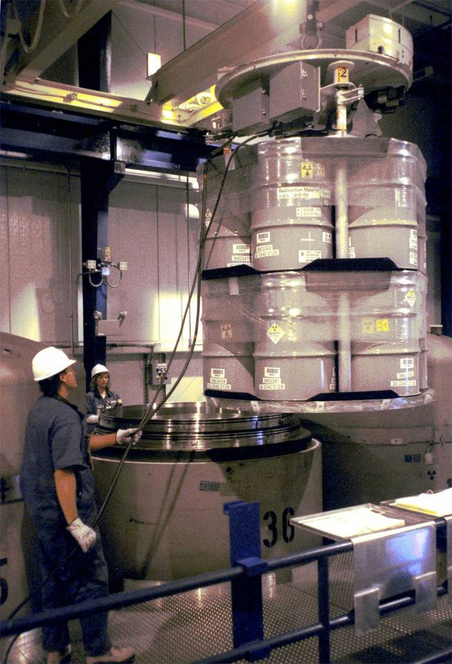 Fluor Daniel nuclear chemical operators, Kevin Hope, left, and Kathy Polotto, help load fourteen 55-gallon drums of radioactive waste into one of three special stainless steel containers at the Waste Receiving and Processing Facility on the Department of Energy's Hanford Site near Richland, Wash., Wednesday, June 14, 2000. This shipment of waste, which consists of clothing, tools, rags and other debris from the nuclear weapons program, will be the first of many over the next 30 years to be transported to the Waste Isolation Pilot Plant, the D.O.E.'s site near Carlsbad, N.M., where it will be permanently stored.