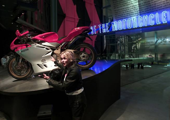 Actress Lauren Hutten points to a motorcycle during pre-opening festivities for the Guggenheim Las Vegas museum at The Venetian hotel-casino Thursday, October 4, 2001. The inaugural exhibit at the new museum is "The Art of the Motorcycle". The 63, 700 sq. ft. exhibition hall opens to the public Sunday.