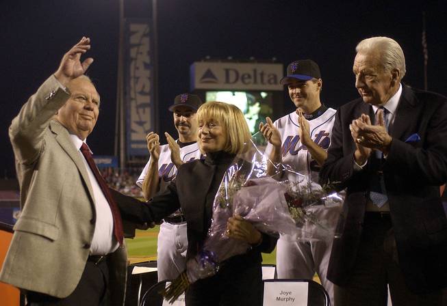 New York Mets announcer Bob Murphy, left. acknowledges fans as his wife Joye, fellow broadcaster Ralph Kiner, right, pitchers John Franco and Al Leiter applaude at a ceremony to celebrate his career as the with the Mets before a game against the Pittsburgh Pirates at Shea Stadium in New York, Thursday, Sept. 25, 2003. Murphy, the Mets announcer since 1962, will retire after tonights game.