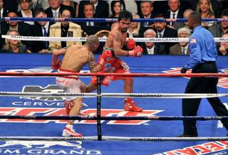 Manny Pacquiao and Miguel Cotto in the final seconds of their fight, and Manny celebrating his victory, at MGM Grand Garden Arena on Nov. 14, 2009.