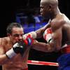 Juan Manuel Marquez (left) takes a punch from Floyd Mayweather Jr. during a welterweight fight at MGM Grand Garden Arena on Sept. 19, 2009. Mayweather won the 12-round fight by unanimous decision.