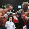 Juan Manuel Marquez (left) battles with Floyd Mayweather Jr. during a welterweight fight at MGM Grand Garden Arena. Mayweather won the 12-round fight by unanimous decision.