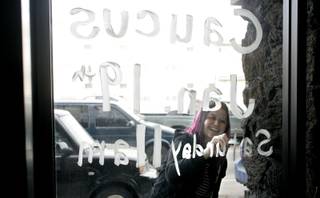 In the hours leading up to Saturday's democratic caucus, The Sun visited two small Nevada towns at the center of political attention - Elko and Searchlight. On Thursday Jan. 17, 2008, Barack Obama volunteer Julie Stutznegger of Salt Lake City, paints a caucus reminder on the window of Obama campaign headquarters in Elko.