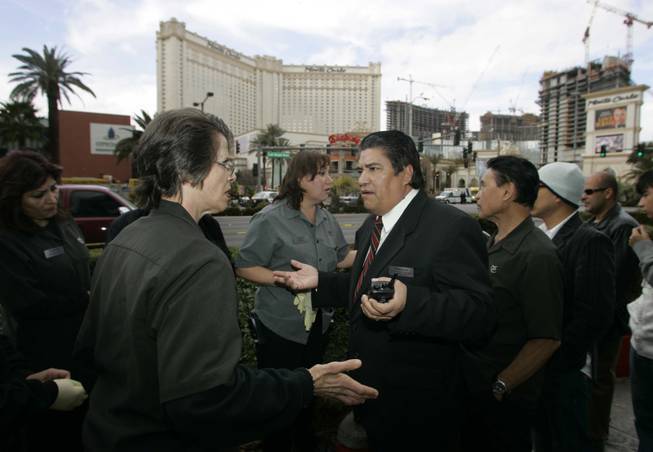 Monte Carlo housekeeping supervisor Roberto Vargas, center, sends workers home ...