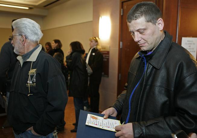 Jason Blackwood, right, leaves court Jan. 14 after graduating from a Mental Health Court program. His next step will be enrolling in vocational rehabilitation, a mental health worker says. The program saves taxpayers money by keeping the mentally ill out of jail.