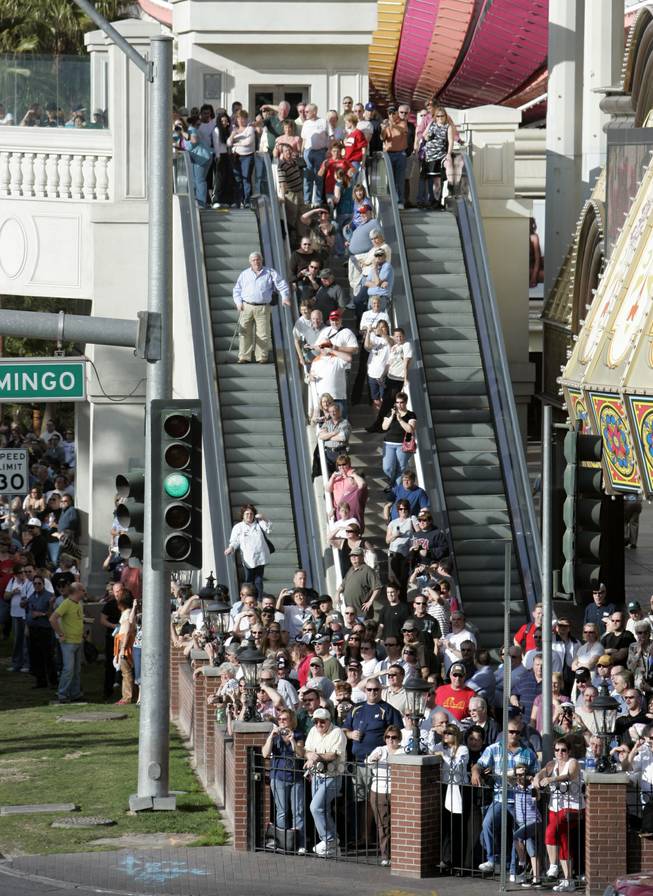NASCAR fans watch as NASCAR car haulers parade northbound on Las Vegas Boulevard Thursday. 