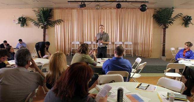 Jack Owen, administrative lieutenant for Metro's South Central Area Command, discusses 2007 police activity statistics with property owners of the Commercial Center shopping plaza Wednesday. Owen said that in one year Metro received 1,168 calls to 953 E. Sahara Road, the center's address.