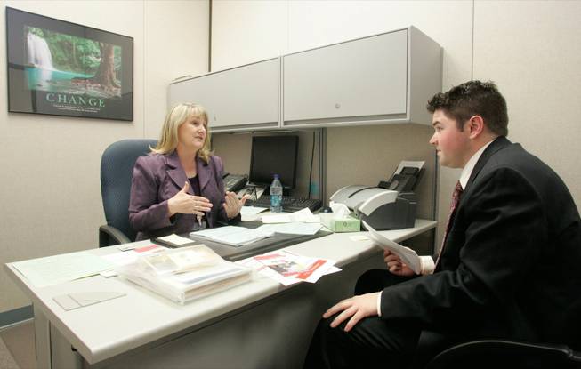 Bonnie Townsend, principal of Hal Smith Elementary School, interviews prospective teacher Brad Peck from Jackson Hole, Wyo., who likes the prospect of slower growth.