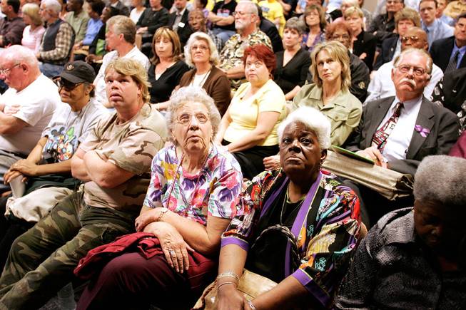 Audience members pay rapt attention to Gov. Jim Gibbons on video during a hearing on the hepatitis C scare in Las Vegas.