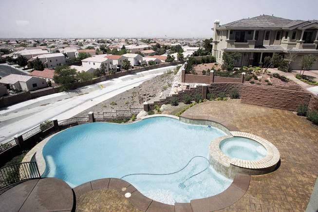 Hardly lived-in 9,400-square-foot Henderson home has 19 rooms, including eight bedrooms. The house and lot feature a mammoth kitchen and entryway, four fireplaces, and a pool and spa. Remarkably, three of the seven houses in the high-end neighborhood off Sunridge Heights Parkway have been in foreclosure.