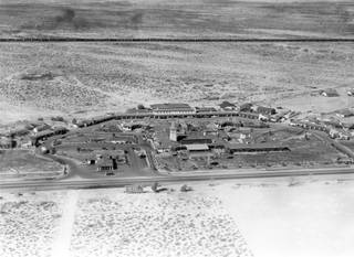 The El Rancho Vegas awaits commuters on Highway 91 (which would later become The Strip) in this late 1940s photo. The El Rancho was the first hotel casino on The Strip to offer gaming, lodging and dining in one location. A long train car can be seen in the distance heading toward downtown.  At the time, the economy of Las Vegas was still reliant on the railroad between Salt Lake City and Los Angeles.