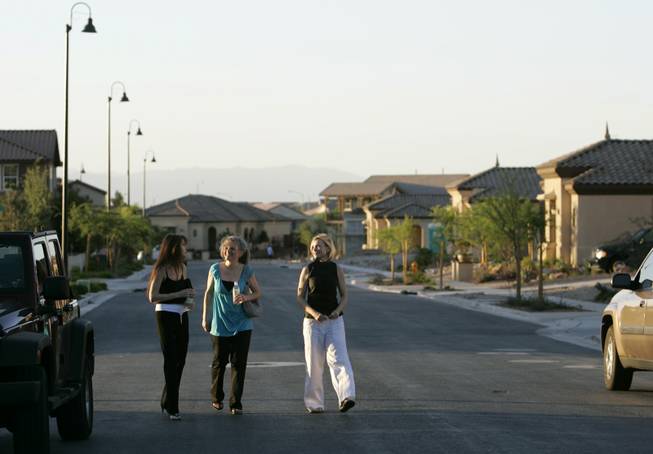 Homeowners, from left, Lacey Hawk, Cynthia McCarty and Nicci Imbert walk through an Inspirada neighborhood Thursday. Construction of the first phase is ongoing. Next up is another section of residences, to be followed by commercial buildings.





