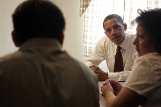 Democratic presidential candidate Senator Barack Obama talks with Francisco Cano, left, and his wife Felicitas Rosel at their home in North Las Vegas. The casino workers told Sen. Obama they are afraid of losing their home to foreclosure.