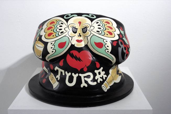 The bust of Tura Satana was painted by Mitch O'Connell, a Chicago tattoo artist and self-described fan of the burlesque performer. 