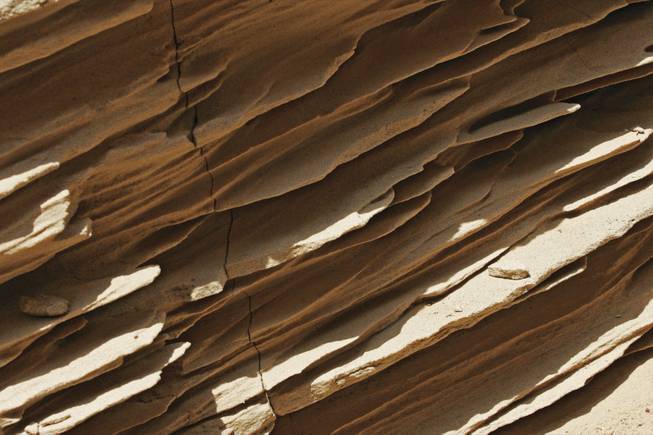 Sandstone in the walls of "Double Negative" has eroded. The Los Angeles museum that owns the work is not conserving it because the artist prefers nature reclaim the land.