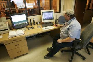 Kelvin Spendlove monitors a machine that compresses solid waste at  the Clark County Water Reclamation District's solids de-watering facility.