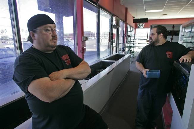 Dan Riggs, left, owner of the Trop-Aquarium, with Vinny Mazzoccoli, says business is down since the store exodus.