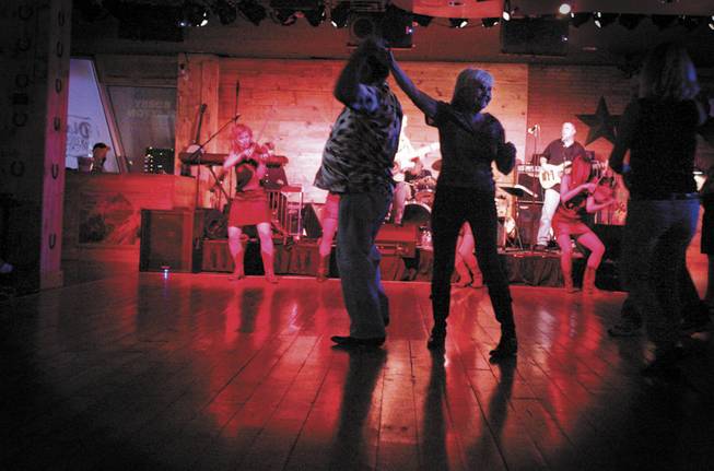 Marty and Ellie Koppel, who have been married for 47 years, dance at Dixie's. Spokesman Joe Donato says country music is perfect for Hooters. "We wanted to create something that would bring people in. Country music and Hooters are a good tie in."