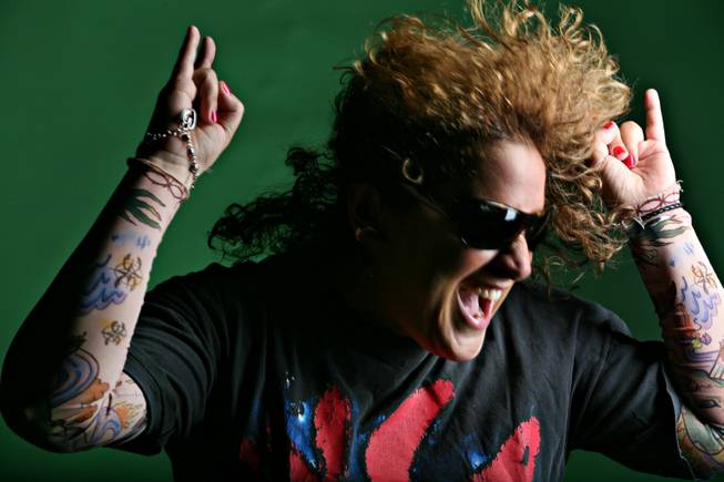 Angela Corvello of Las Vegas poses for portraits before her first air guitar contest this weekend. The Air Guitar Championships will be held Sunday at Harrah's Carnaval Court. Parts of costumes are being sent to her from across the country.