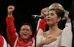 Nicole Angela, 17, sings the national anthem of Philippines before the title fight between Manny Pacquiao of the Philippines and WBC lightweight champion David Diaz of the U.S. at the Mandalay Bay Events Center.