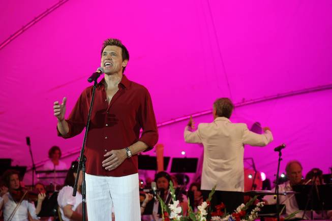 Tenor Brent Barrett, left, performs "All I Care About Is Love" with the Las Vegas Philharmonic orchestra conducted by Director David Itkin during the 10th Anniversary Star Spangled Spectacular celebration at Hills Park in Summerlin.