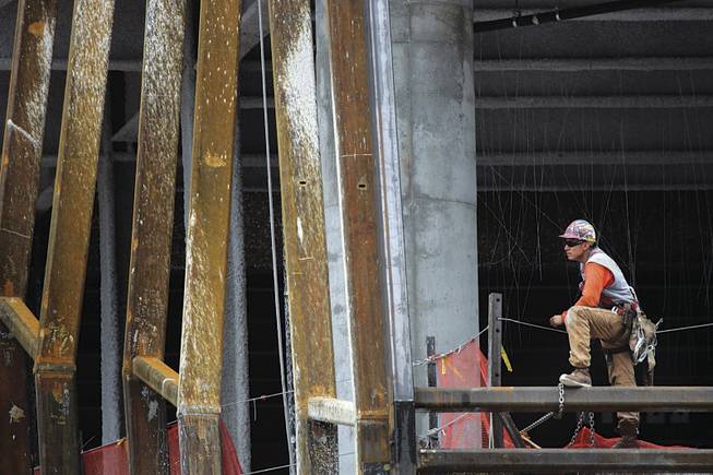 An ironworker looks out from the Cosmopolitan this week. Deutsche Bank, the project's primary lender, took possession of the property after its developer, New York condo builder Ian Bruce Eichner, defaulted on a $760 million construction loan.