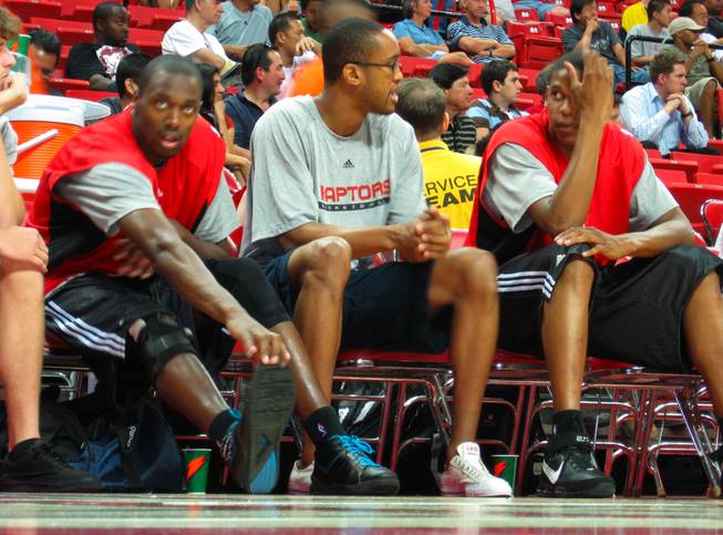 Rod Benson, left, stretches his right knee Friday night on the bench while watching his Toronto teammates play. Benson's week was hampered by a sprained MCL, which he suffered in practice on his first day in Vegas.
