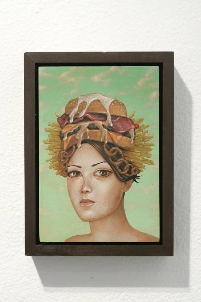 An element of playfulness: Junk food, sex toys, pot pipes, deforestation and festive skulls are all modern-day indulgences in "Traditional American Headdresses, Series 2."