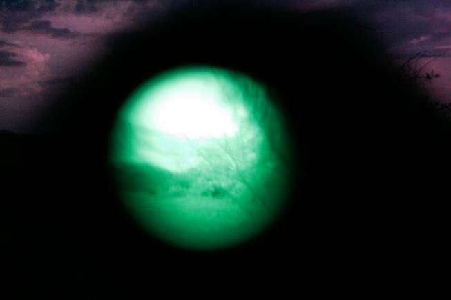 This is my first, and probably last attempt to take a photo with my camera through infrared goggles. It didn't work like I thought it would, but the effect was nice. The Minuteman Civil Defense Corps use these goggles to spot illegal immigrants during a "muster." A muster is what they call their gatherings to watch the borders or high traffic areas for illegal immigrants. On this night they were stationed on a ranch near Amado, Ariz.
They ended up spotting 13 alleged illegal immigrants. All 13 of them were eventually picked up by Border Patrol. -- Leila Navidi