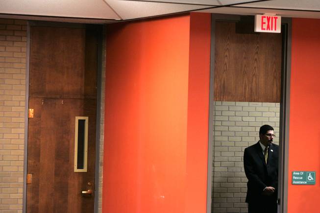 Inside the Main Library in downtown Albuquerque, while Barack Obama addressed a gathering of women at an invitation-only event, this member of the Albuquerque Police Department stood watch in one of the stairway exits of the building. I liked the way he was watching the stairway quietly, framed by the colorful wall of the library's periodical and newspaper section on the second floor. He was so still and watchful, he almost could have passed for a Secret Service agent. - Leila Navidi