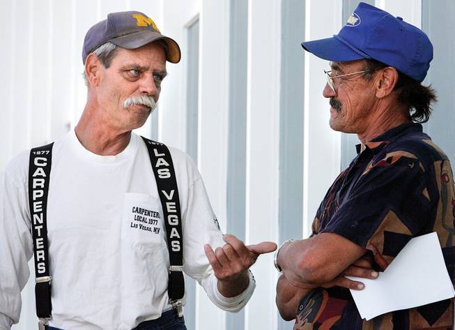 David Schoenherr, left, of Michigan and John Bawman of Montana talk Friday at the Southwest Regional Council of Carpenters hall. They're thinking of moving to Canada for work.