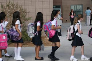 Students line up outside for the Ruben P. Diaz Elementary School's dedication and ribbon-cutting ceremony. Students at this school follow a recommended dress code.