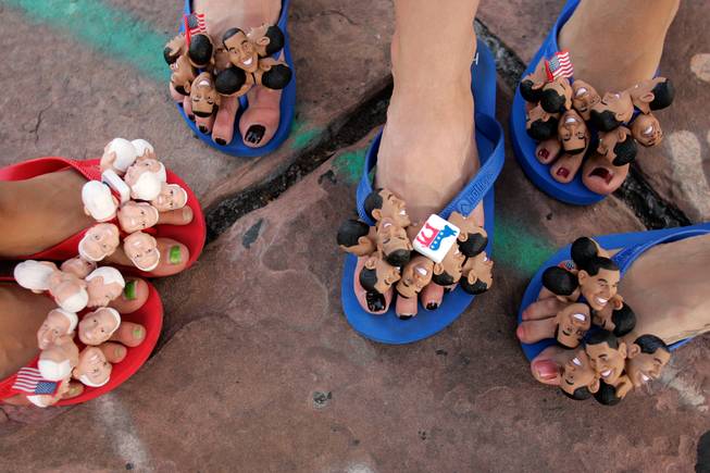 Lesson of the day: look down. As a photographer, I'm always looking left, right, forward, backward and even up. Sometimes I forget to look down. I did when passing by this group of cheerful flip-floppers Tuesday. They were selling them (of course), and paused for a moment to pose together for my first flip-flop portrait. -- Leila Navidi