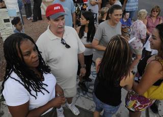 Guy Smith, left, organized a protest walk on Saturday to demand action from county officials to improve pedestrian safety at the crosswalk at the intersection of Las Vegas Boulevard and Wigwam Avenue. Smith's neighbor, Verlaine Powless, was struck by a car and killed at that intersection on July 25.