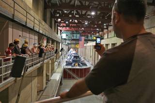 Visiting Nevada from Turkey, Ersin Seyhan captures a photograph on his cell phone of the seven-story-high hydroelectric generators while taking the Power Plant Tour at the Hoover Dam.