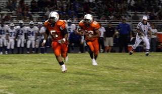 Chaparral's Padric Hall (5) blocks for Isaiah Washington during Friday's game against Basic.