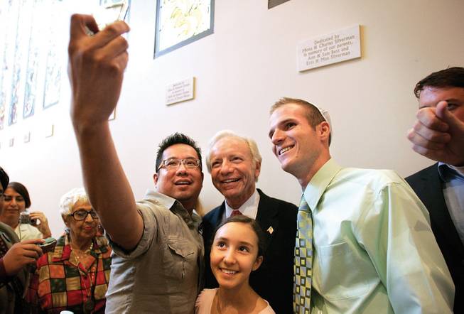 
John Garcia snaps a picture of Ariella Nounna, 12, and Dallas Holmes with Connecticut Sen. Joe Lieberman during a campaign visit at Temple Beth Sholom in Las Vegas this week.