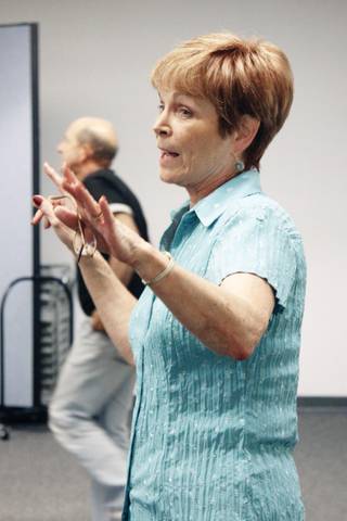 Toni Molloy-Tuda, education director for the Rainbow Youth Company, talks with some of the young actors and crew members during a rehearsal at the Reed Whipple Cultural Center.