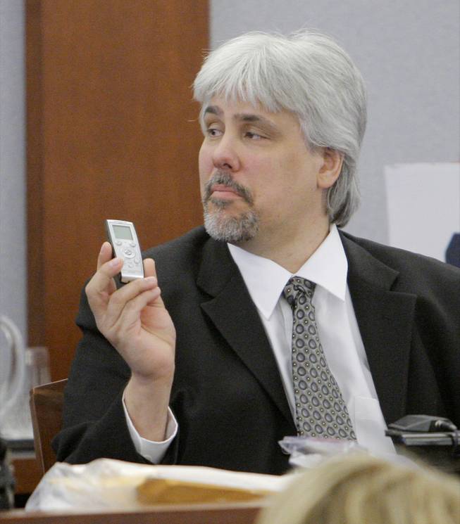 Collectibles dealer Thomas Riccio holds up an audio recorder as he testifies Thursday afternoon, Sept. 18, 2008, during O.J. Simpson's trial at the Clark County Regional Justice Center in Las Vegas. Simpson faces charges that include burglary, robbery and assault following an alleged robbery at the Palace Station Hotel & Casino in September 2007.