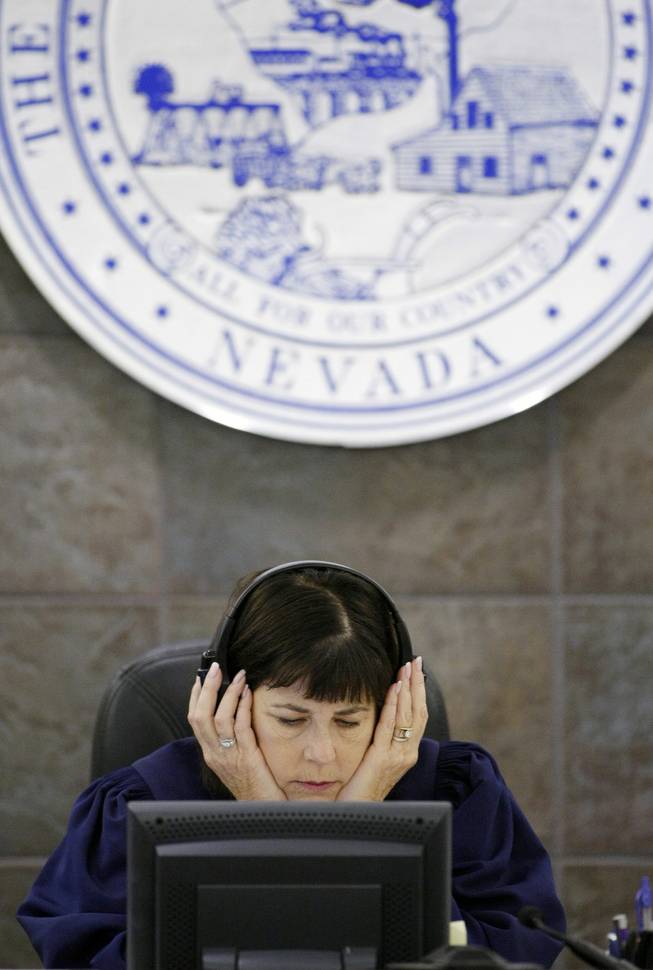 Judge Jackie Glass listens to recordings during O.J. Simpson's trial in Las Vegas, Friday, Sept. 19, 2008. Simpson faces 12 charges, including felony kidnapping, armed robbery and conspiracy. 