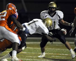 Spring Valley's Jacques Adams (1) loses the football during a broken play at the line during Friday's game against Bishop Gorman.