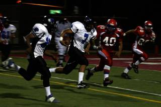 Desert Pines quarterback Dalton Leilua runs the ball for a touchdown during the third quarter of Friday's victory at Valley.