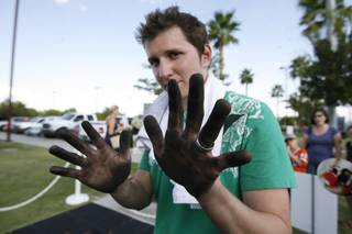 Donovan Fitzgerald shows his hand as he takes a break from painting a mural on the sidewalk in chalk Saturday during the eighth-annual Summerlin Art Festival, a free event that drew more than 10,000 visitors to Summerlin Centre Community Park.
