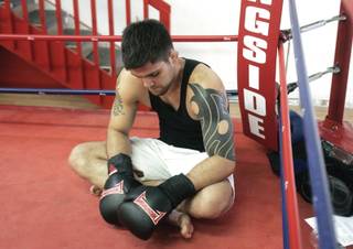 Mixed martial arts fighter Robert Drysdale takes a moment to rest during his training session at JSECT Modern Martial Arts. Drysdale is preparing for his first MMA fight in October.