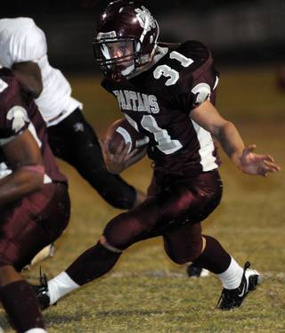 Spartan running back Zach Barbara (31) looks for a gap in the line during a run against the Panthers at Cimarron-Memorial High School Friday.