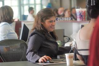 Customer service representative Rosio Venegas works one of nine walk-up customer service windows at the Cox Communications Henderson Retail and Payment Center Oct. 6.