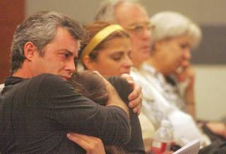 Jon Reale comforts his wife, Patty, as they listen to the 911 call Reale made during the sentencing Thursday of Vincent DiBerardino for the murder of Reale's mother, Stephanie Zweig.