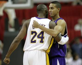 Los Angeles' Kobe Bryant (24) and Sacramento's Kevin Martin share a hug just before tip-off of Sunday night's game at the Thomas & Mack Center. The Lakers held on to defeat the Kings, 94-89, to pick up their first win of the preseason.