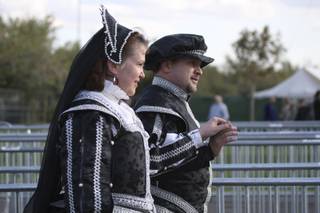 Arriving fashionably late, Ted Sell escorts his wife, Sandy, to the ticket booth of the Act of Chivalry Renaissance Festival on Saturday.
